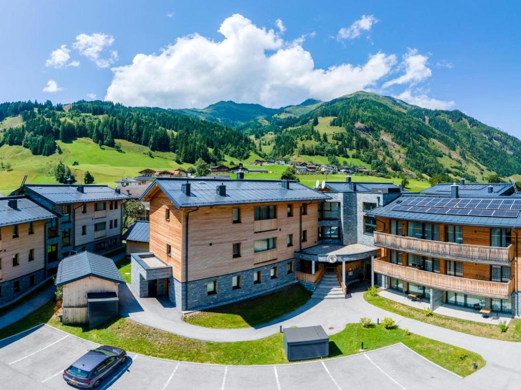 an aerial view of a building with mountains in the background at Spacious suite for 8 guests with a private sauna in Rauris