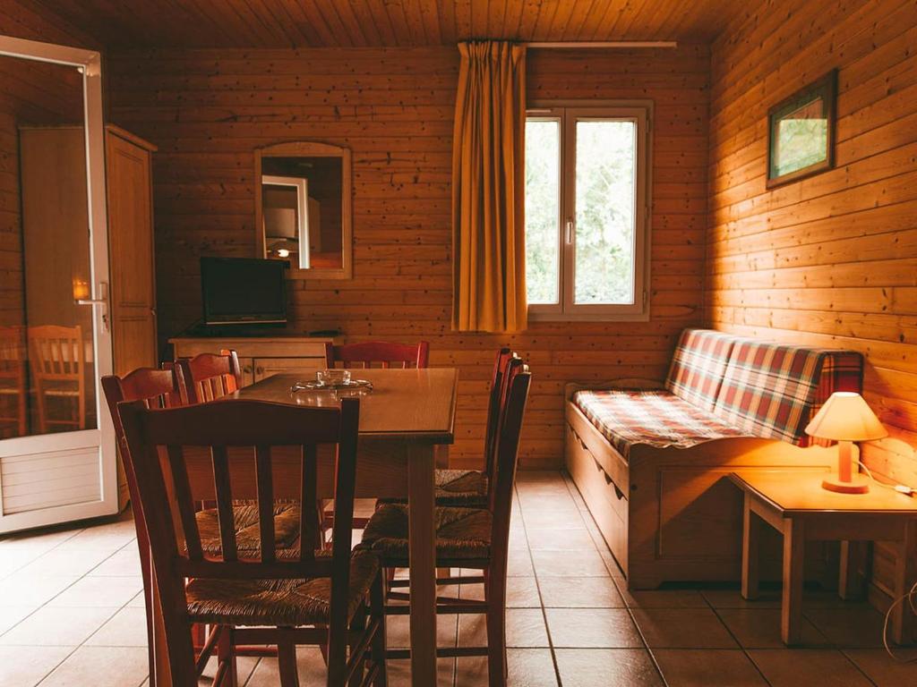 a living room with a table and a couch in a room at Cozy Cottage Retreat for Two in Moutiers-sous-Chantemerle
