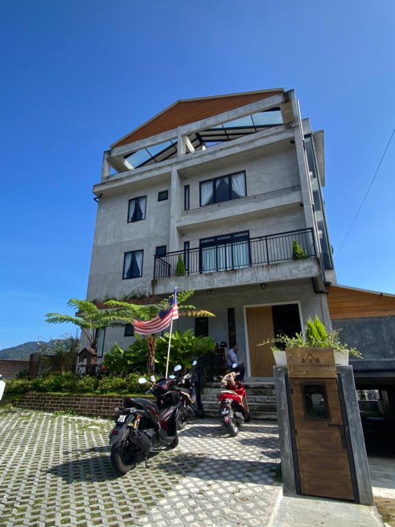 two motorcycles parked in front of a building at Silvan Garden Retreat in Tanah Rata