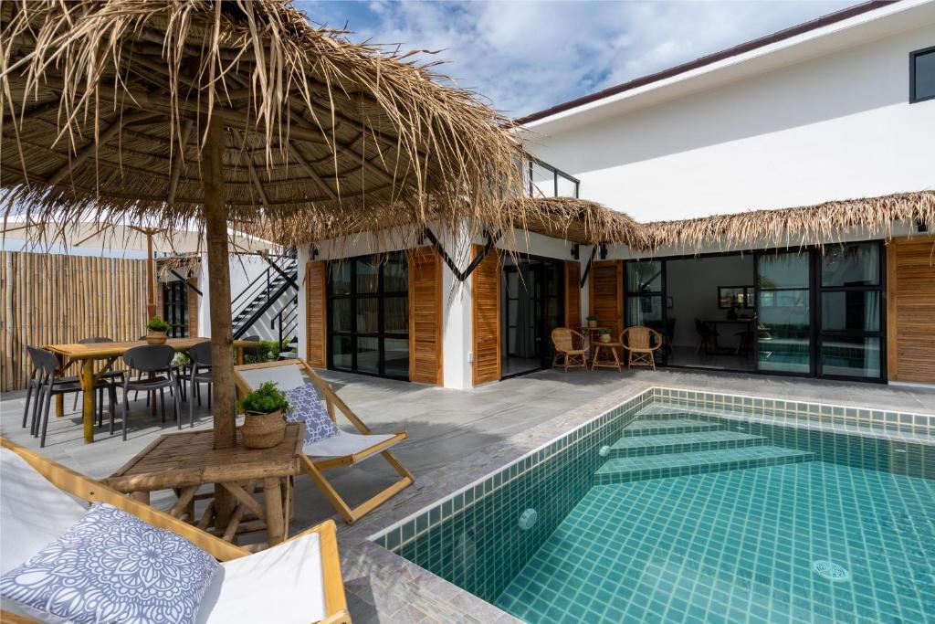 a villa with a swimming pool and a resort at Manao Pool Villa 9 - 5 Mins Walk To The Beach in Ko Lanta