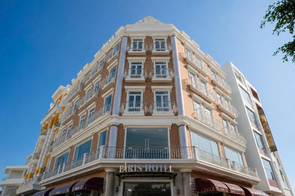 a tall building with a balcony on the side of it at Paris Hotel Châu Đốc in Chau Doc