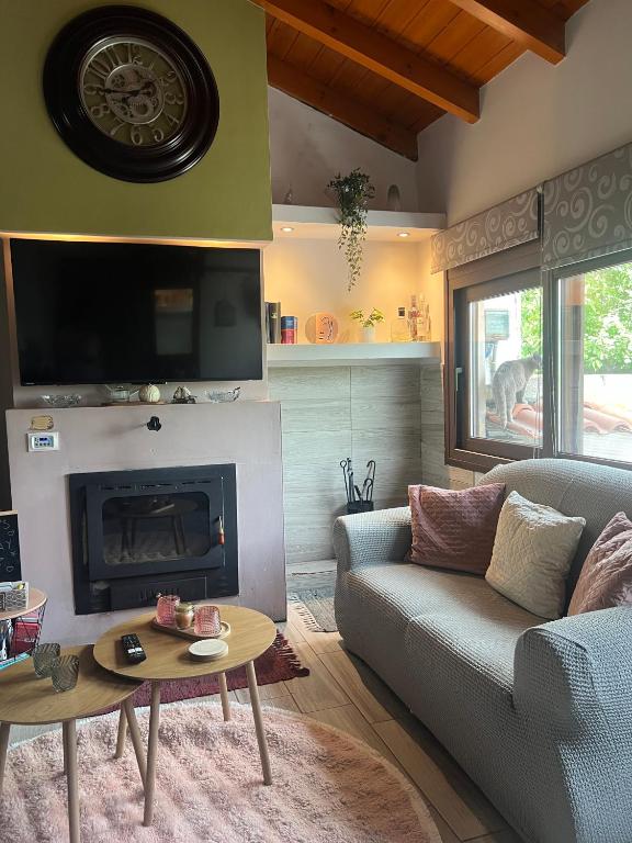a living room with a couch and a fireplace at Chalet Dirfys - Escape in the heart of Evia in Kambiá