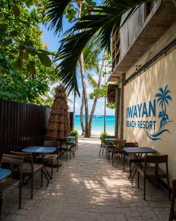 a row of tables and chairs at a restaurant on the beach at Iwayan Beach Resort in Panglao Island