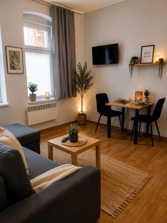 a living room with a couch and a table at DalkoskaStreet in Gniezno