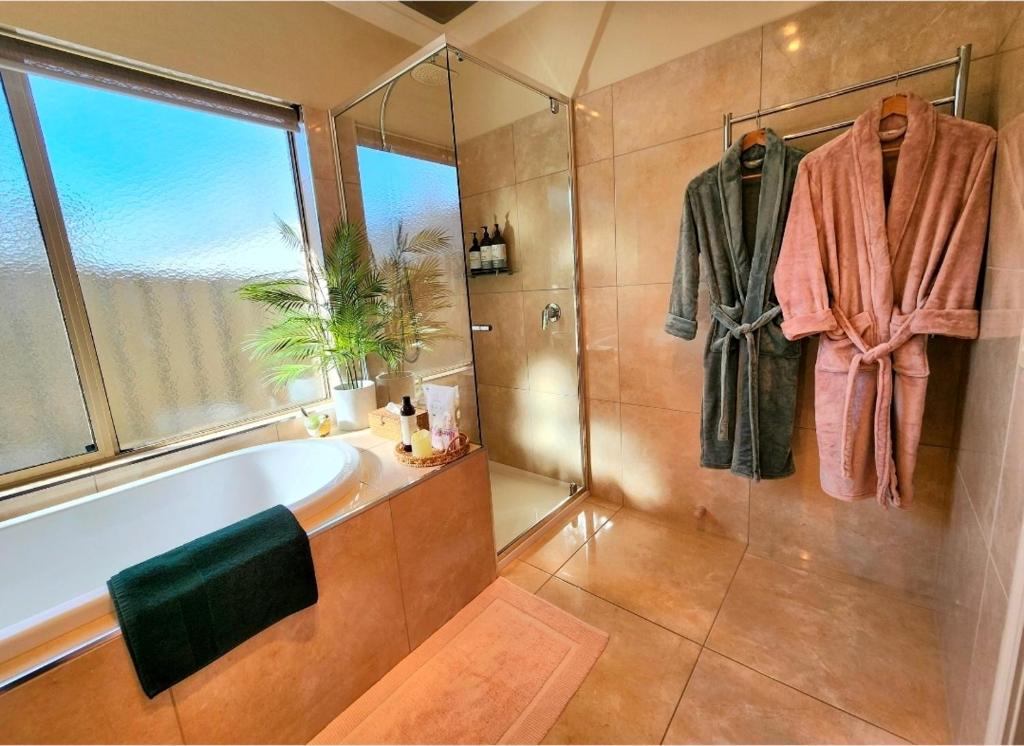 a bathroom with a bath tub and a window at The Nest at Forest Lake - Stylish Guest Suite in Kangaroo Flat