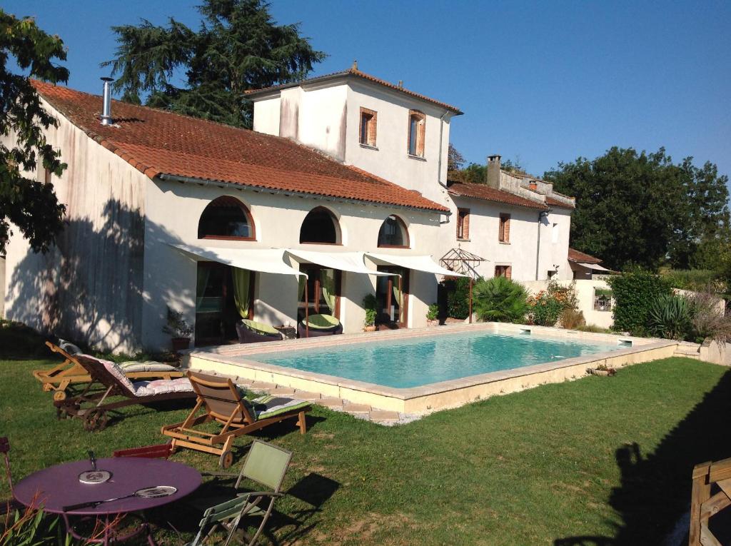 a house with a swimming pool in the yard at La Ferme De Sicard in Terssac