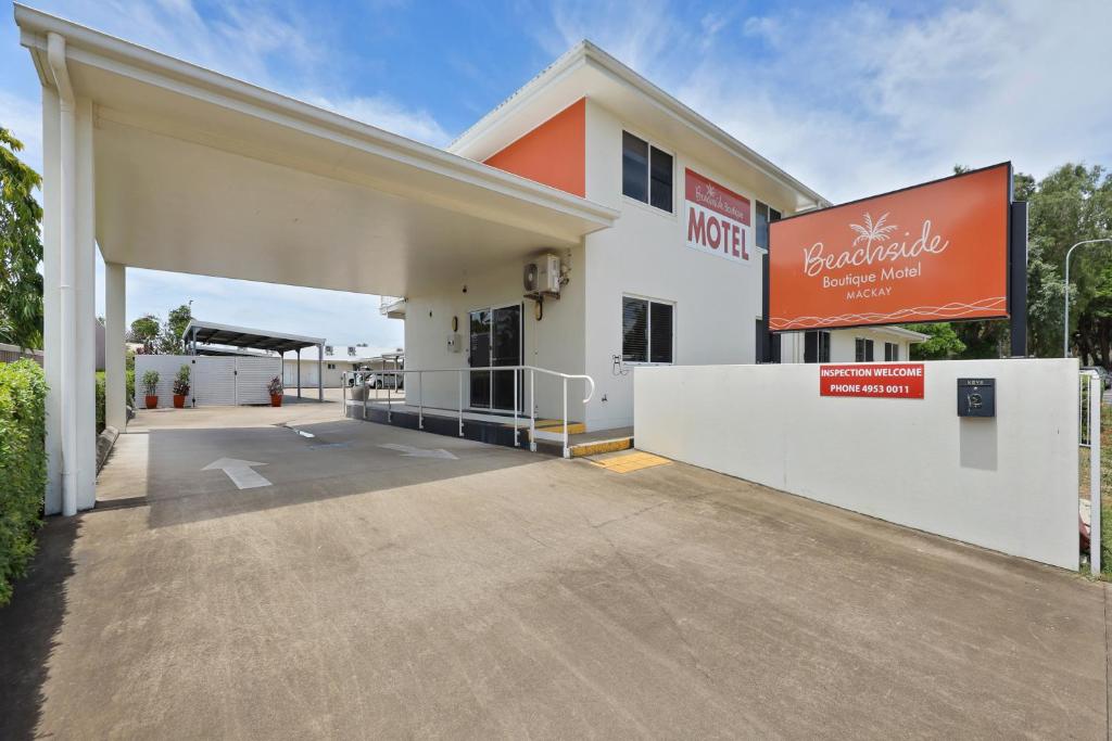 an empty parking lot in front of a building at Beachside Boutique Motel Mackay in Mackay