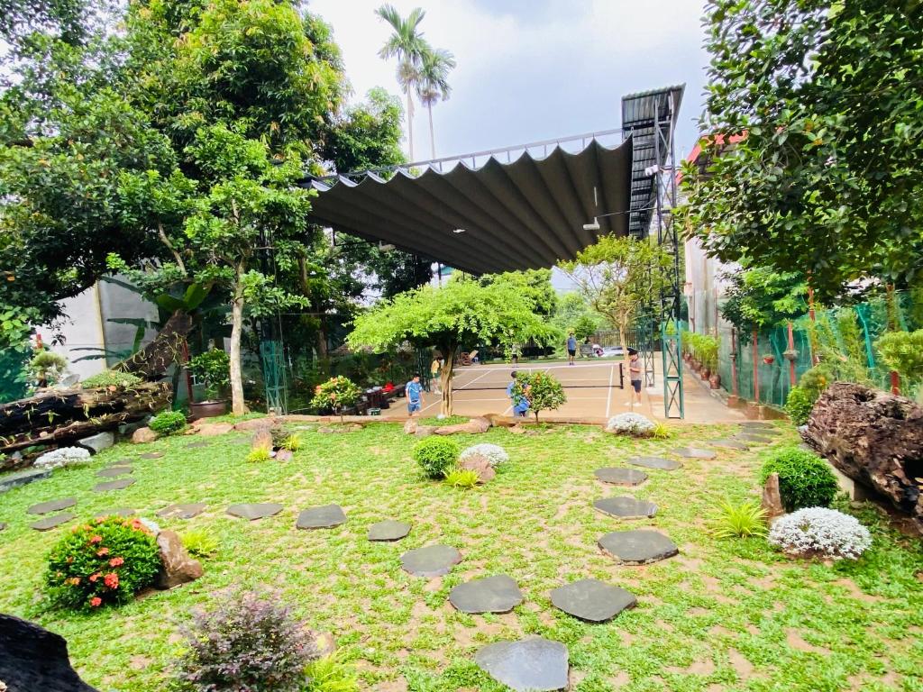a garden with rocks on the grass at Homestay-pickleball in Ðồng Vo