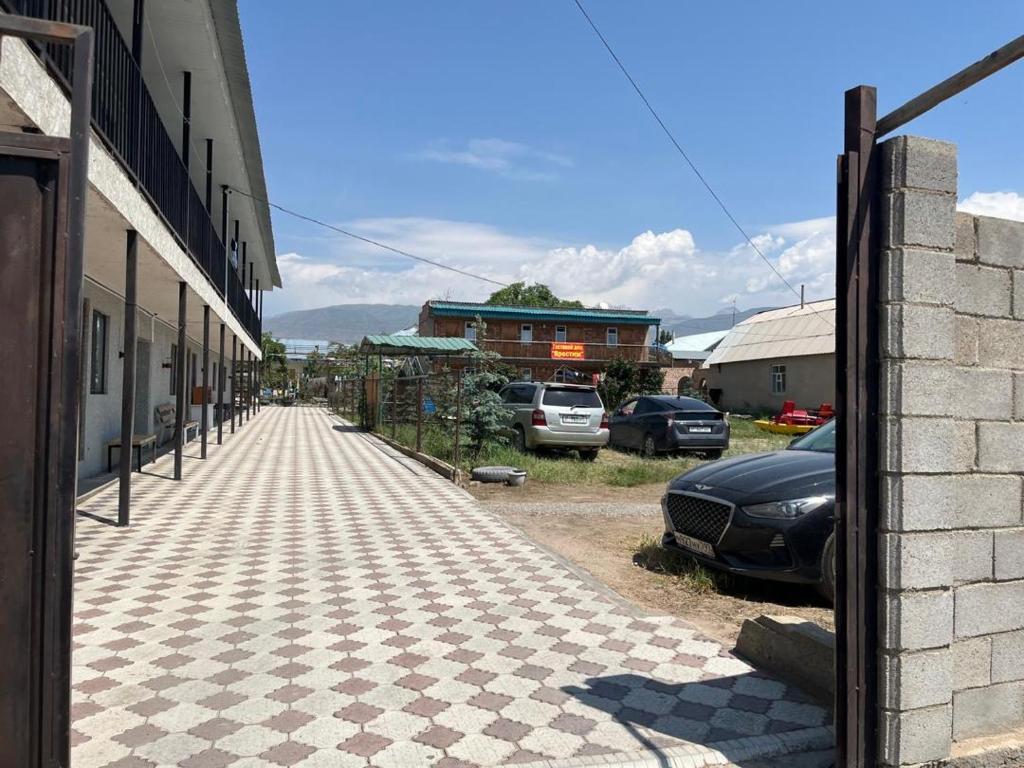 a street with cars parked on the side of a building at Prestizh Guest House in Tamchy