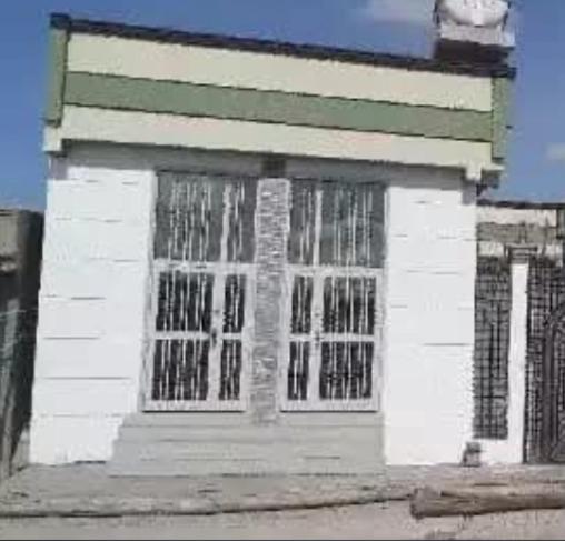 a white building with windows and a clock on it at sadam nahwi in Dukem