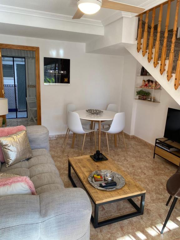 a living room with a couch and a table at Voulez Vous in Lo Pagán