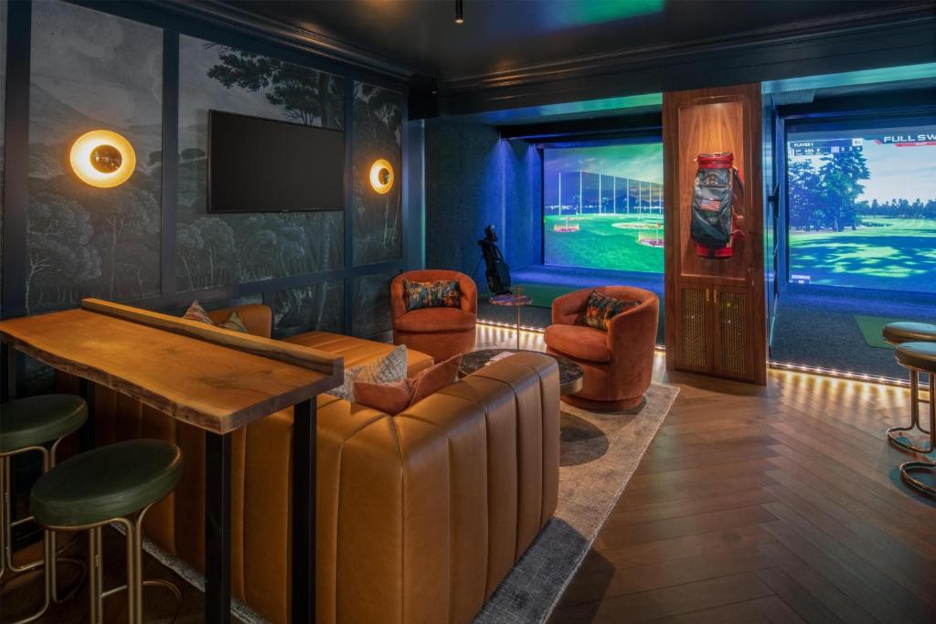 a bar with a couch and chairs in a room at Hotel 1000, In The Unbound Collection By Hyatt in Seattle