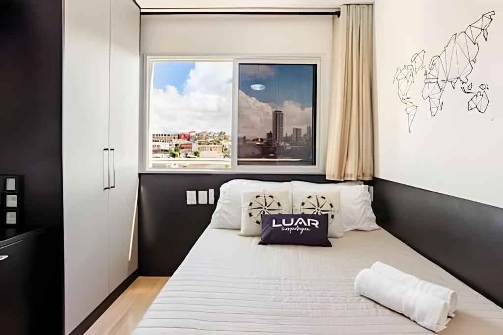 a small bedroom with a bed with a window at Studio Luar 611: Executivo Premium - SmartPituba in Salvador