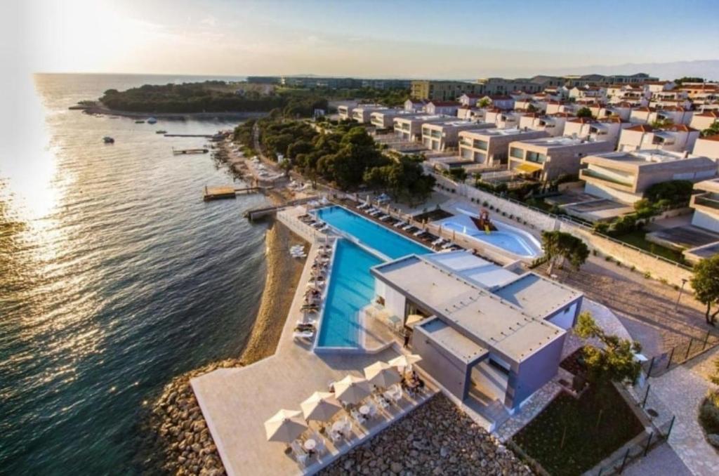 an aerial view of a resort next to the water at Apartman Oscar with pool access in Petrcane