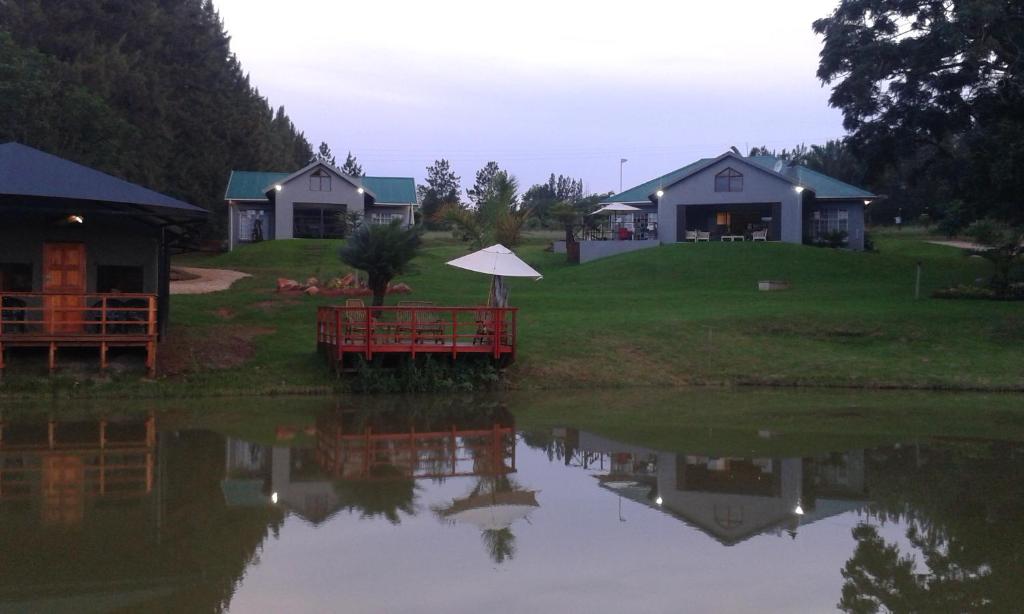 a view of a house from across a lake at Eden Cottage in White River