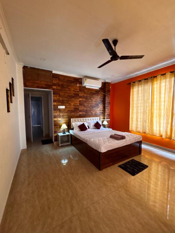 a bedroom with a bed and a ceiling fan at Niyor Nest in Guwahati