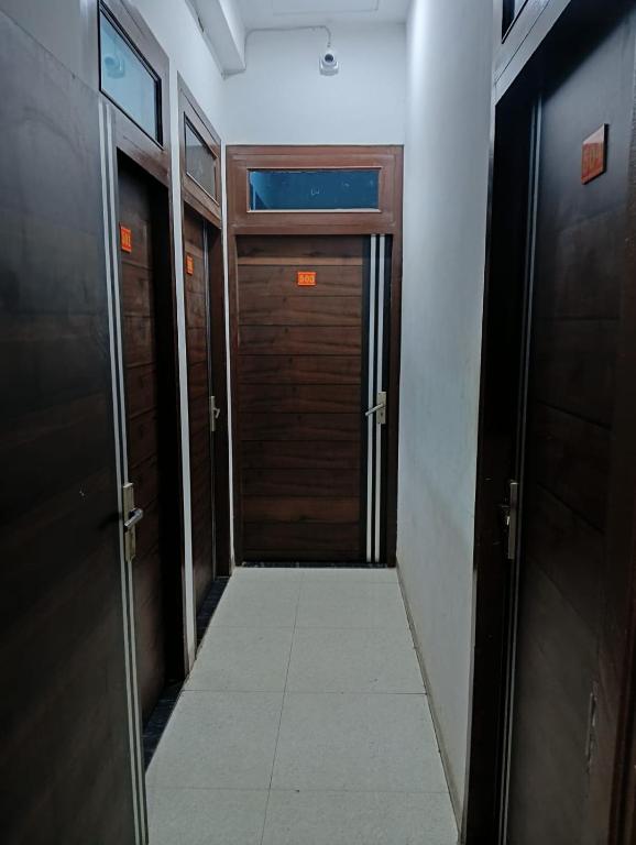a hallway with two doors and a tile floor at Hotel welcome in Rīngas