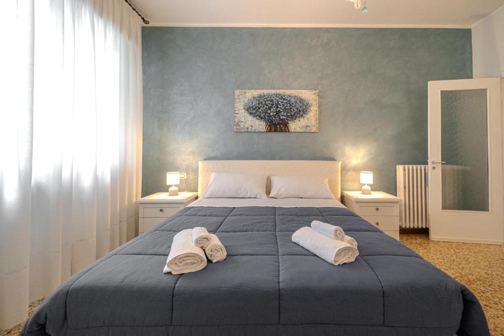 a bedroom with a large bed with towels on it at Casa Lella in Novara