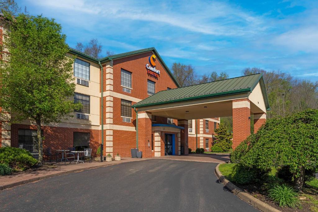 a hotel with a sign on the front of a building at Comfort Suites Pittsburgh Airport in Coraopolis