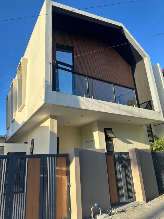 a modern house with a black fence at The Perch House in Silañgang Mayao