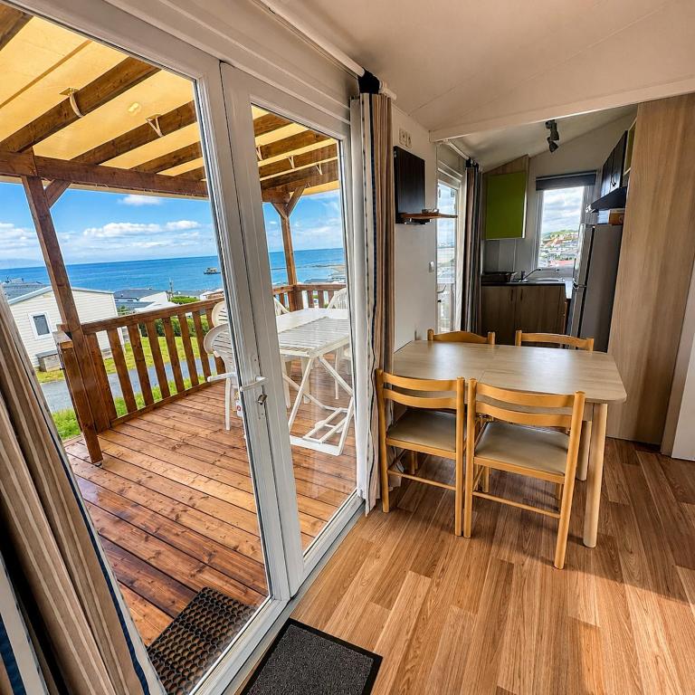 a dining room with a table and a view of the ocean at Blueportel Horizon L40 in Le Portel