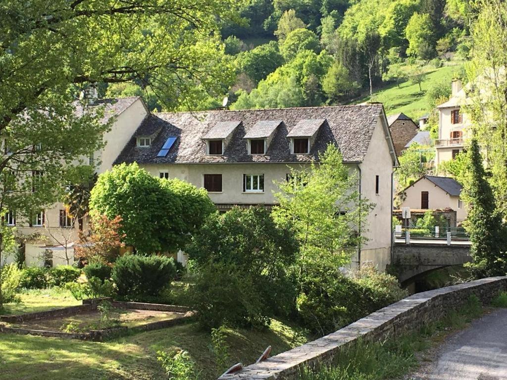 a house in a village with a bridge at Chez Mikki in Cassaniouze