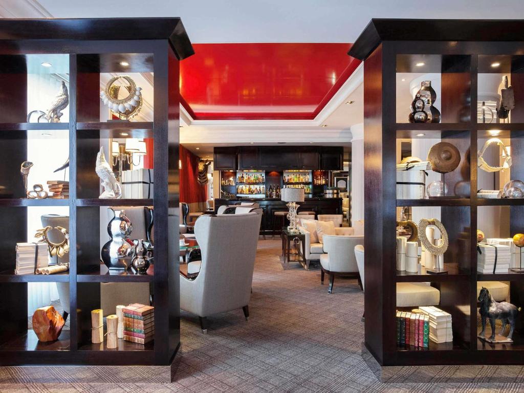 a room with a store with chairs and shelves at Park Hotel Grenoble - Handwritten Collection in Grenoble