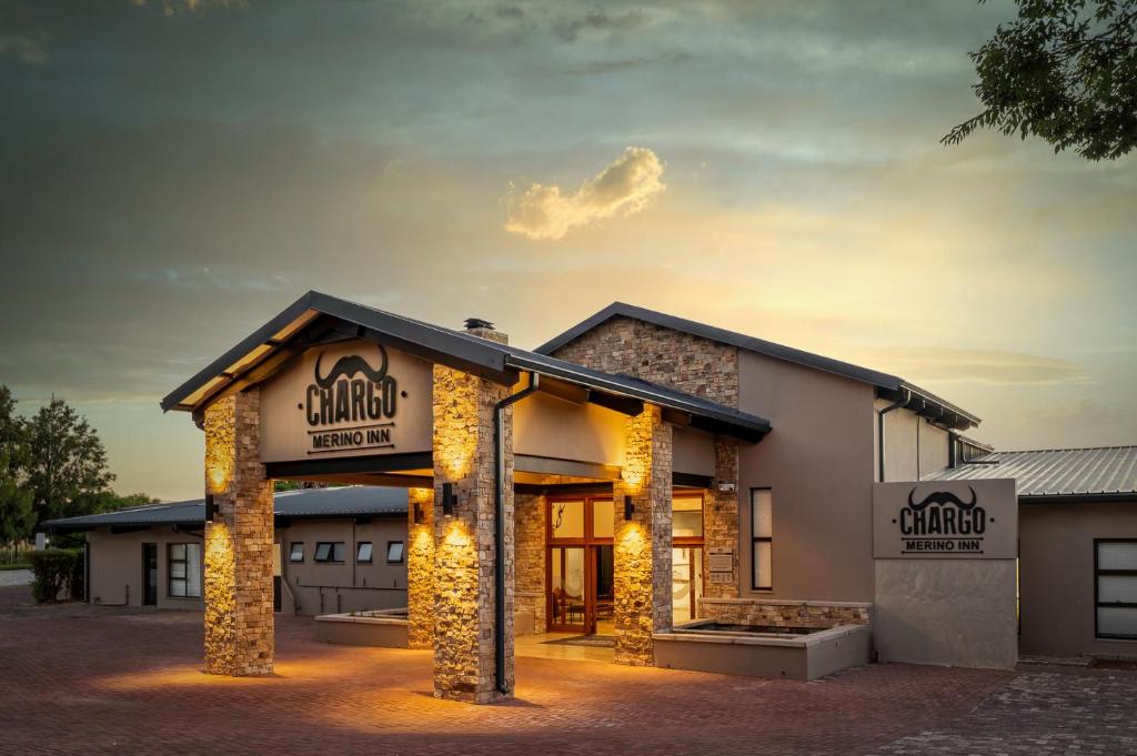 a building with lights on the front of it at Merino Inn Hotel in Colesberg