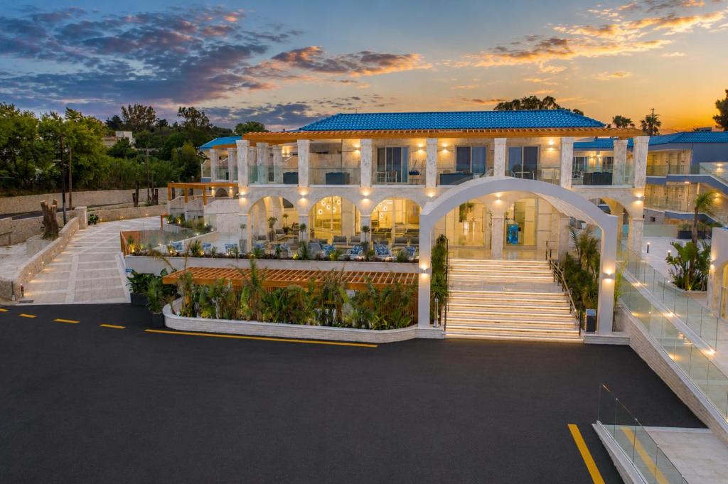 a large white building with an arch in a parking lot at Kalithea Horizon Blu - Adults Only in Kallithea Rhodes