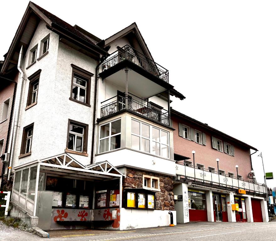 a white building with a balcony on the side of it at Garni Sternen in Obstalden