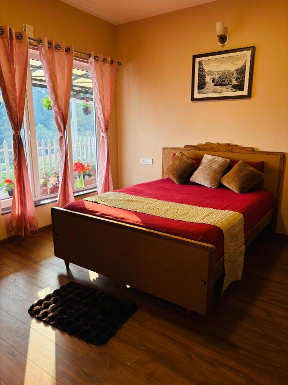 a bedroom with a large bed with red sheets and two windows at Rosewood Camellia - Near Ooty Town in Ooty