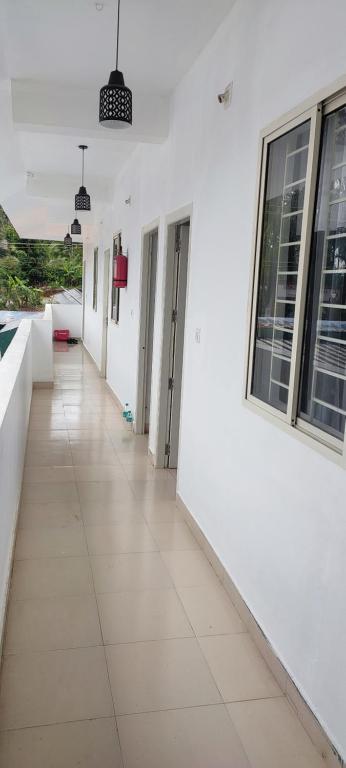 an empty hallway of a building with white walls at Kanchan Grace in Vaduvanchal