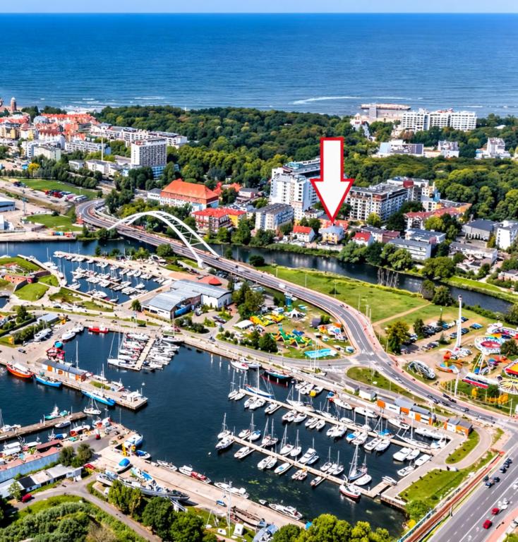 an aerial view of a marina with a red arrow at Villa Kapitańska in Kołobrzeg