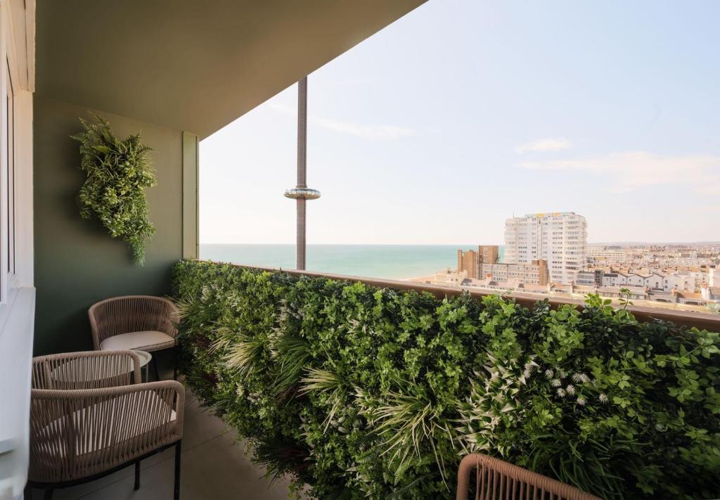a balcony with chairs and a view of the ocean at Sunset Apartment - 7th Floor Double Tree in Brighton & Hove