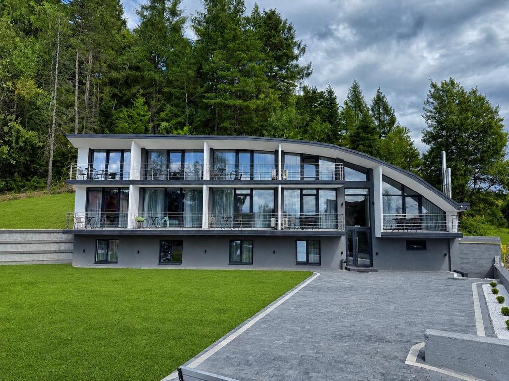 a large house with a large building with windows at VELAR Apartment in Skhidnitsa