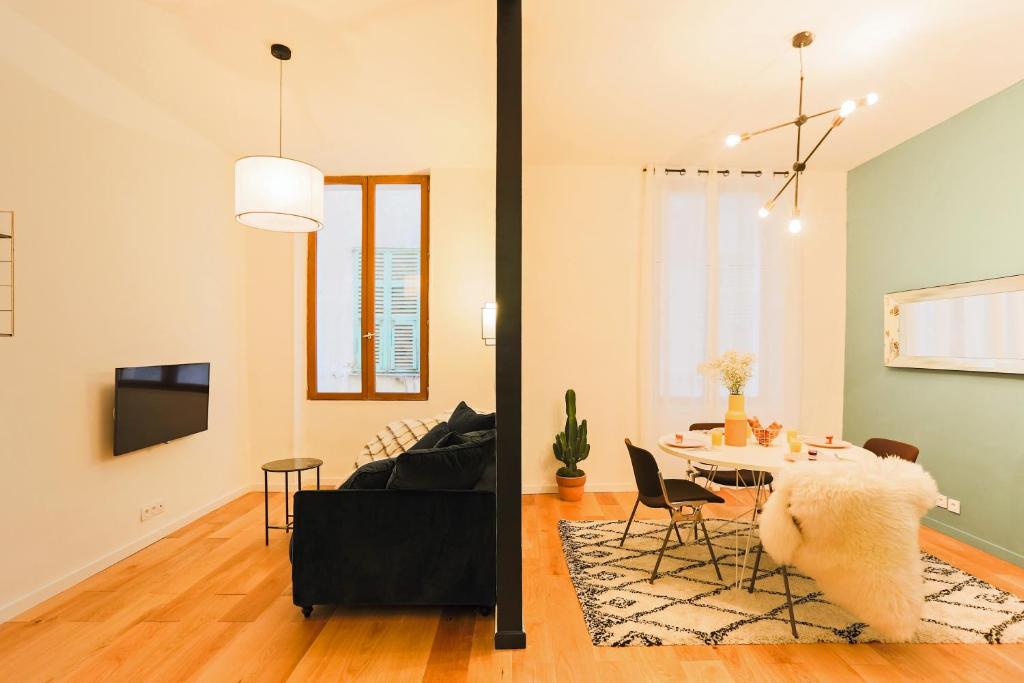 a living room with a table and a couch at Moulin -Old Town in Nice