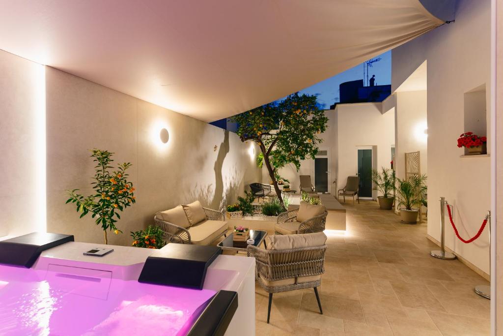 a living room with couches and tables and plants at B&B Palmares Rooms & Suites in Taviano