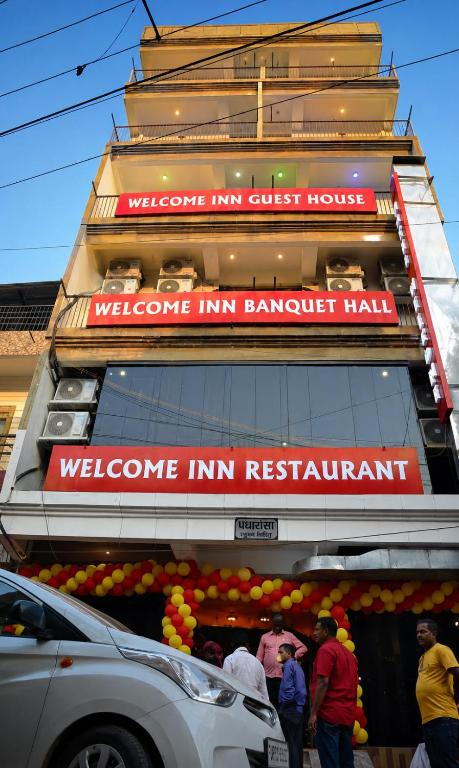 a store front of a building with people standing outside at Hotel Welcome inn in Patna