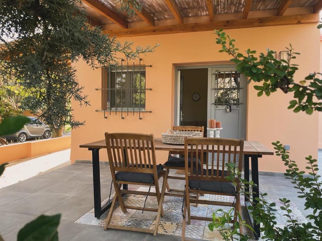 a table and two chairs on a patio at The Beach House at Oz Bay in Pantoukiós