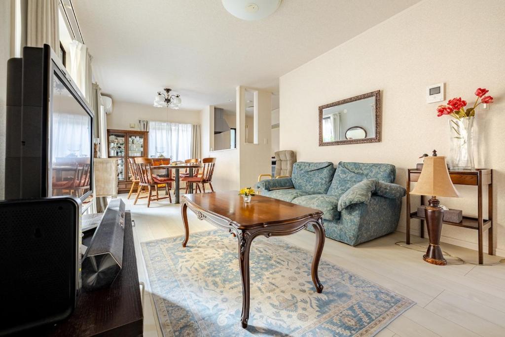 a living room with a couch and a table at Sea Breeze 三浦 in Miura