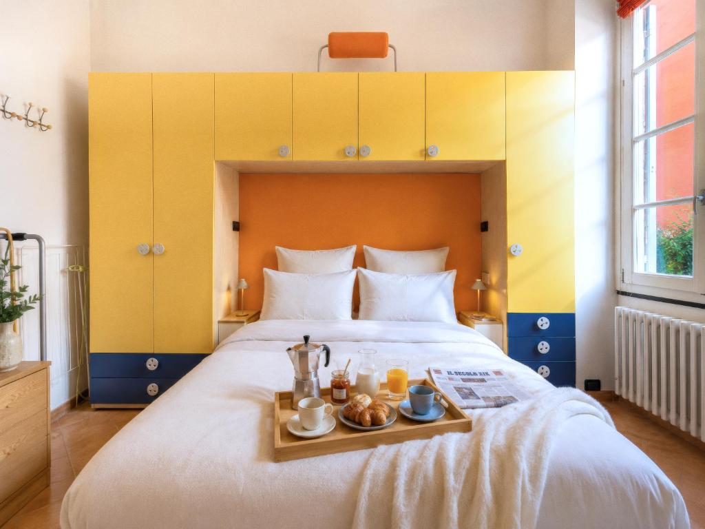 a bedroom with a large bed with a tray of food on it at Rivierarent Casa Nemo in Finale Ligure