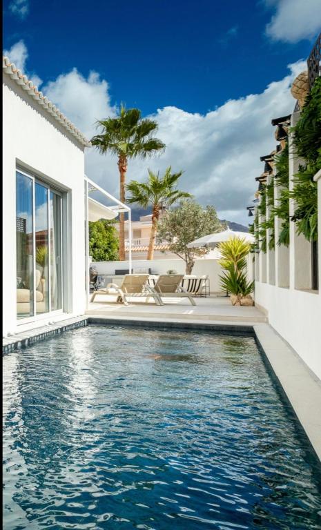 a swimming pool in the backyard of a house at New Villa Los Olivos in Adeje