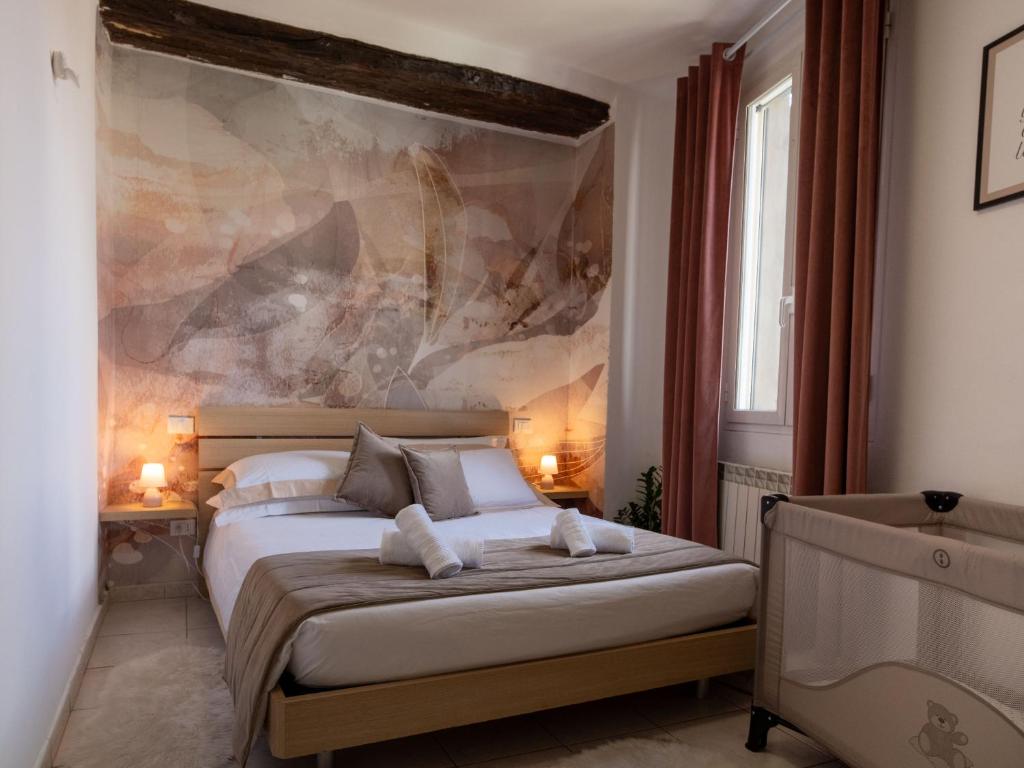a bedroom with a bed with two towels on it at Nel centro storico di Ovada in Ovada