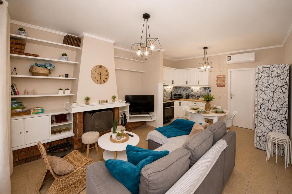 a living room with a gray couch and blue pillows at Pipetos house in Acharavi