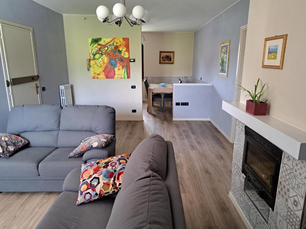 a living room with a couch and a fireplace at CASA VACANZE FRANCIACORTA in Colombaro