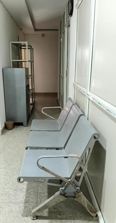 a empty chair in a room with a window at Nasa Hostel in Panchanai