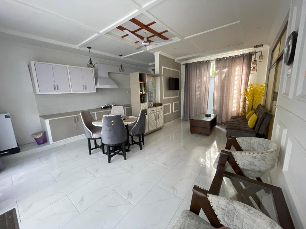 a kitchen and living room with a table and chairs at The Northleaf Cottage in Skardu