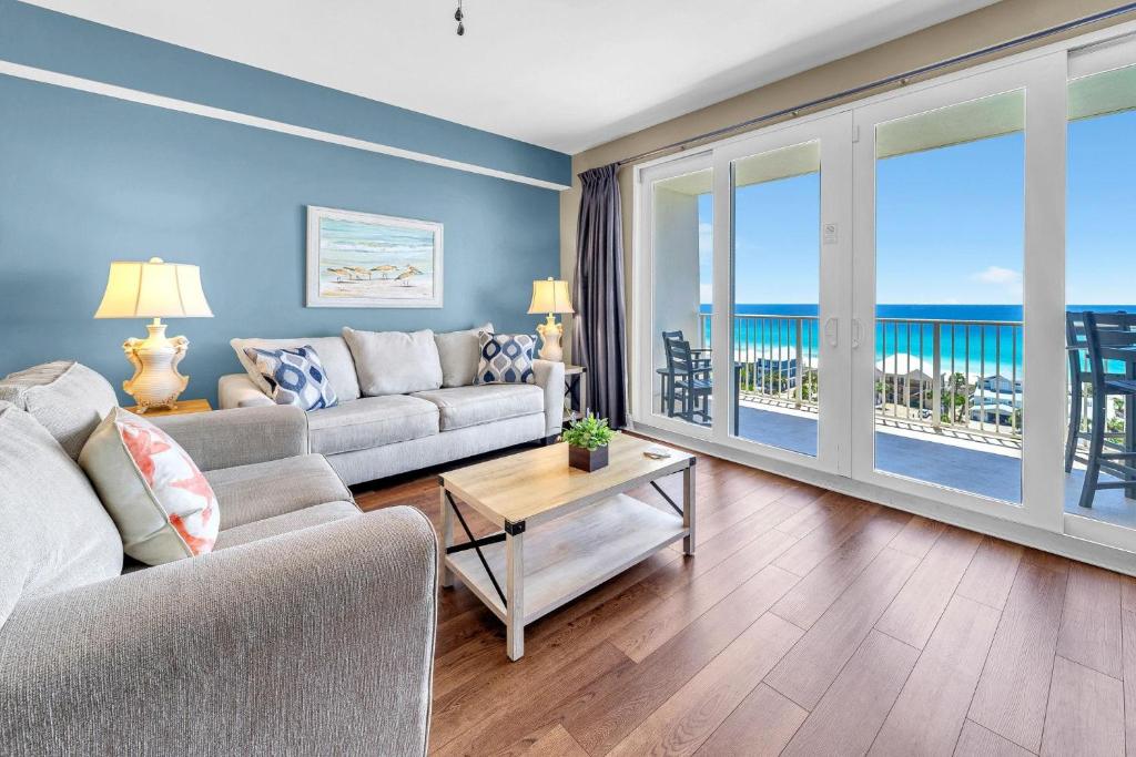 a living room with a couch and a view of the ocean at Laketown Wharf 903 in Panama City Beach