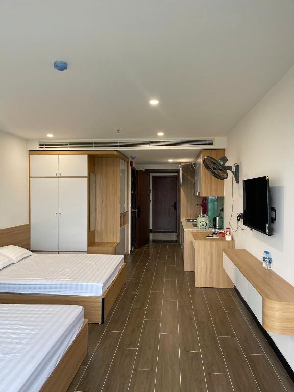 a large room with two beds and a kitchen at L'Azur Cửa Lò in Cửa Lô