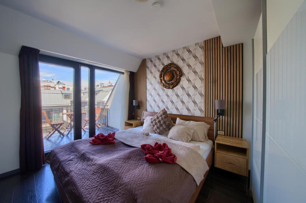 a bedroom with a bed with red bows on it at Budapest Center Residence in Budapest